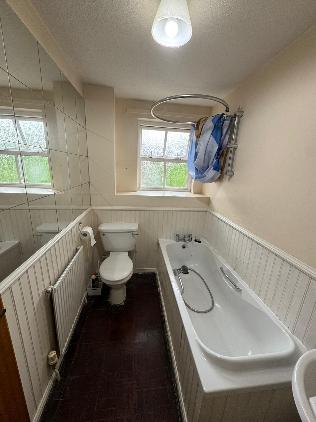 The original bathroom with an over-bath shower before conversion to a walk-in shower by Adsett Bathrooms