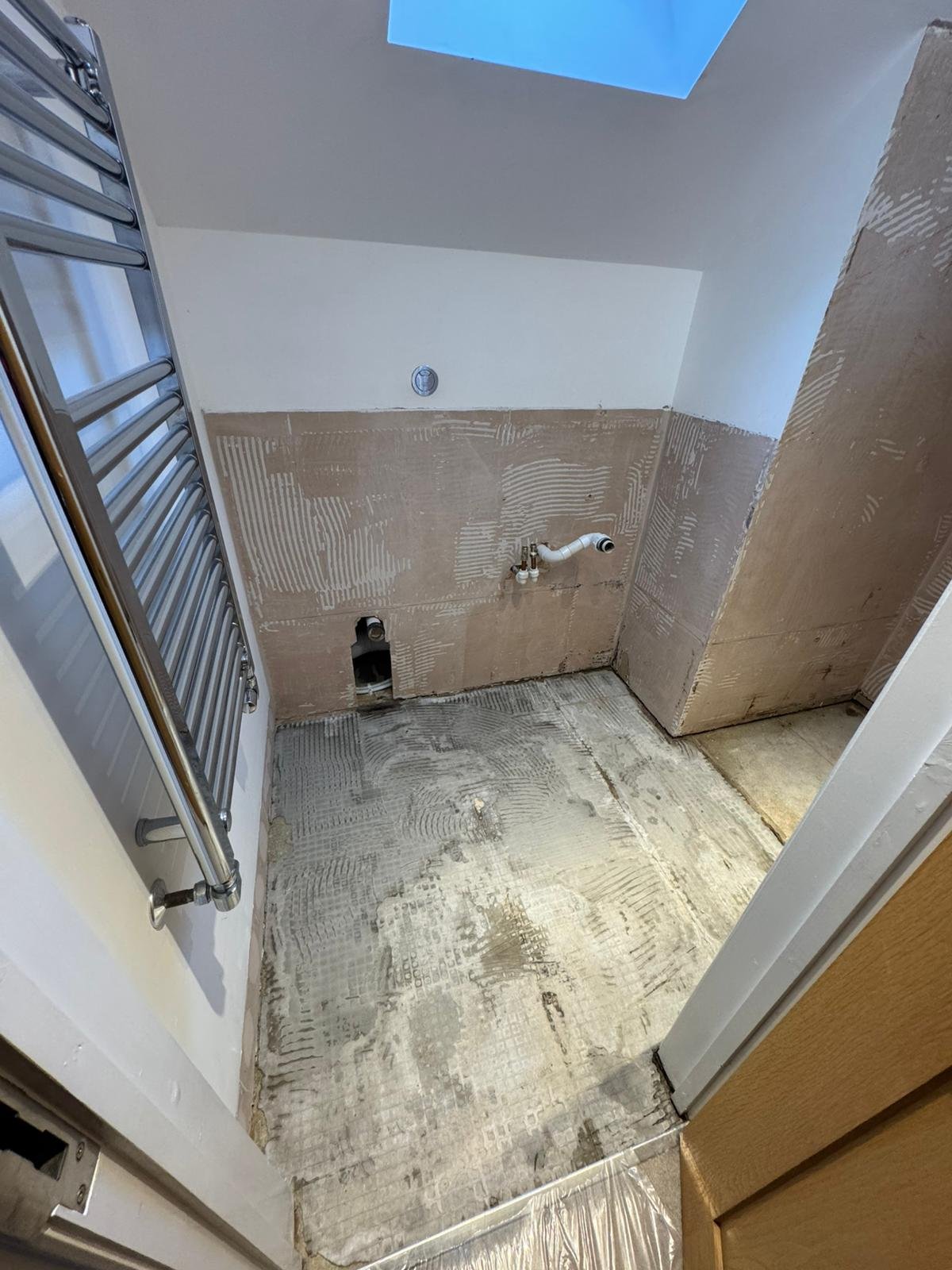 Leaking shower stripped back to bare walls showing water damage, before repair by Adsett Bathrooms in West Sussex