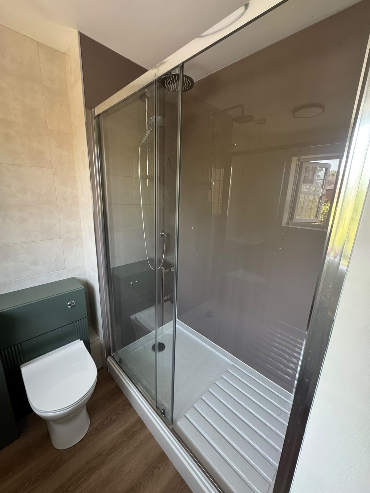 Completed shower room with tiled feature wall and recessed niche in West Sussex — Adsett Bathrooms