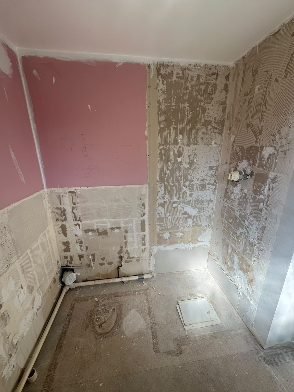 Bathroom stripped back to bare walls and floor before a new shower room was fitted in West Sussex