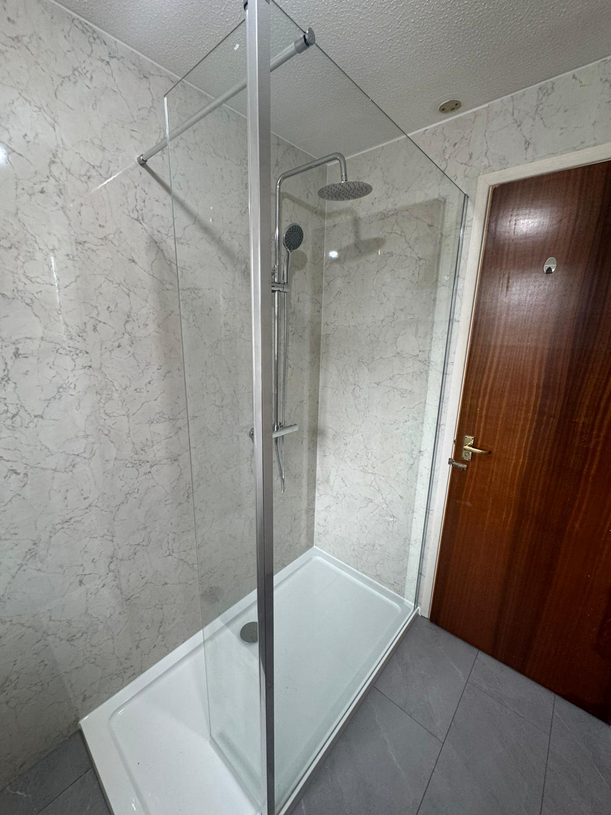 New walk-in shower clad in marble-effect Multipanel wall panels with a low-access tray by Adsett Bathrooms