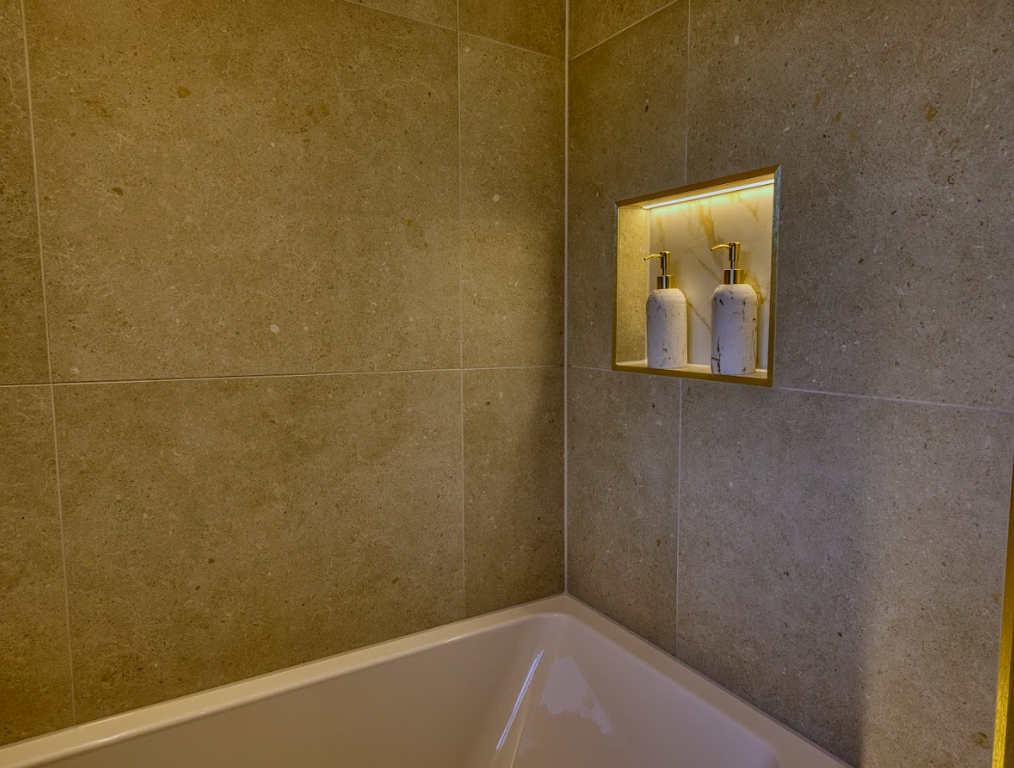 Recessed shower niche with accent tiles for bathroom storage