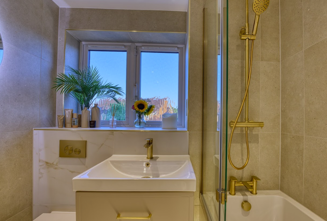 Wall-mounted basin with natural light from bathroom window