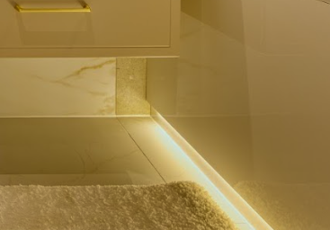 LED under-cabinet lighting detail in renovated bathroom